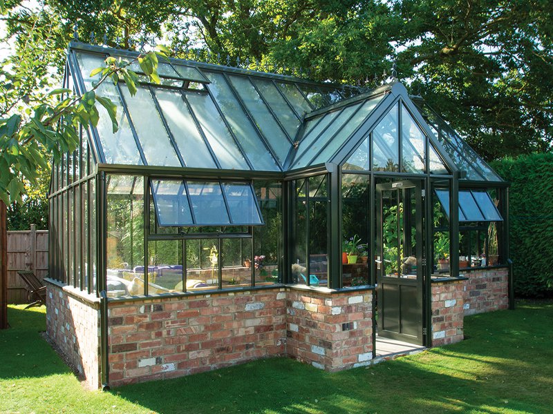 Victorian style steel and glass greenhouse for garden